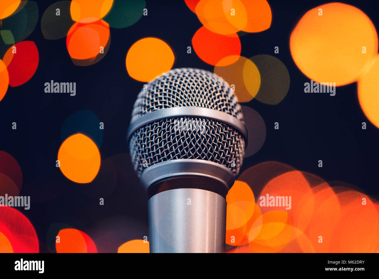 Audio microphone on stage with bokeh light. Music concert or talent show concept with copy space. Stock Photo