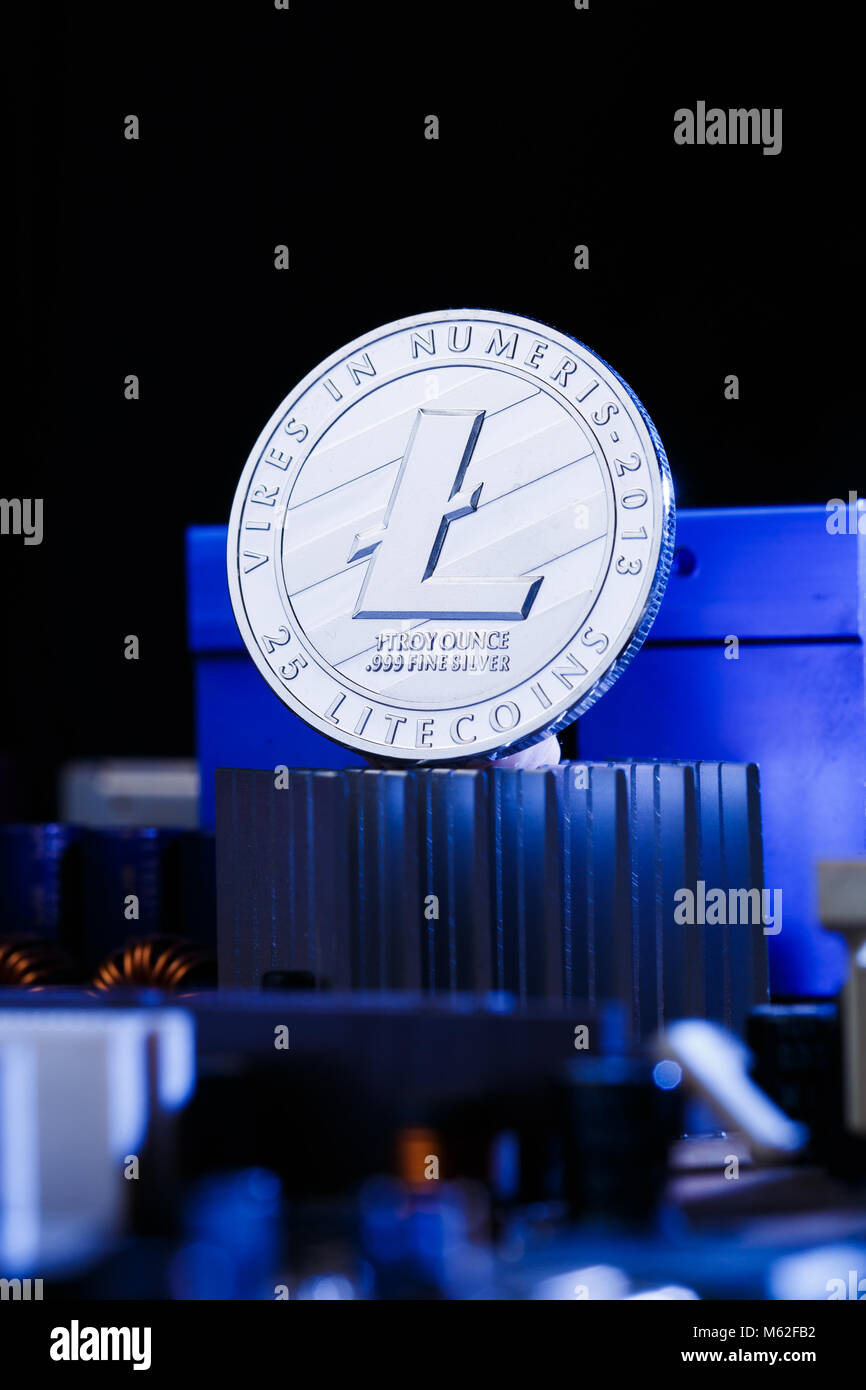 Image of coin litecoin and processor on blue background Stock Photo