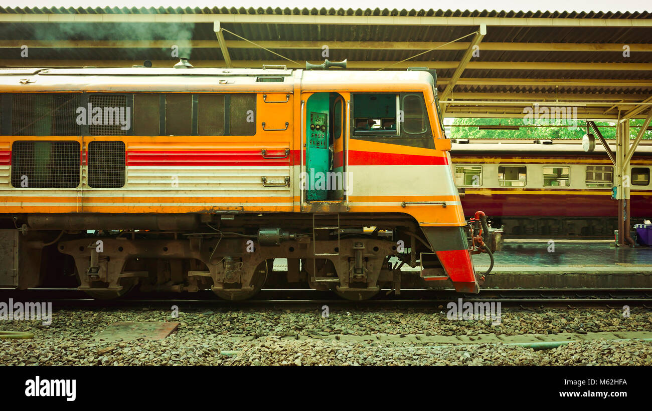 Old diesel train running for reconnect at a platform of railway station Hua Lamphong in Bangkok Stock Photo