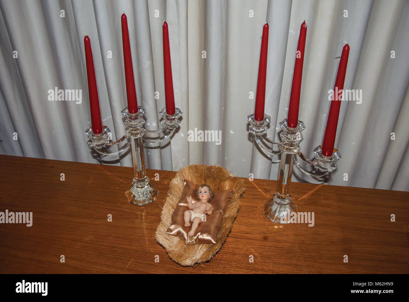 Table with candlesticks and doll representing the birth of Jesus Christ, indoors in Sao Paulo. Famous for its cultural and business vocation. Brazil. Stock Photo