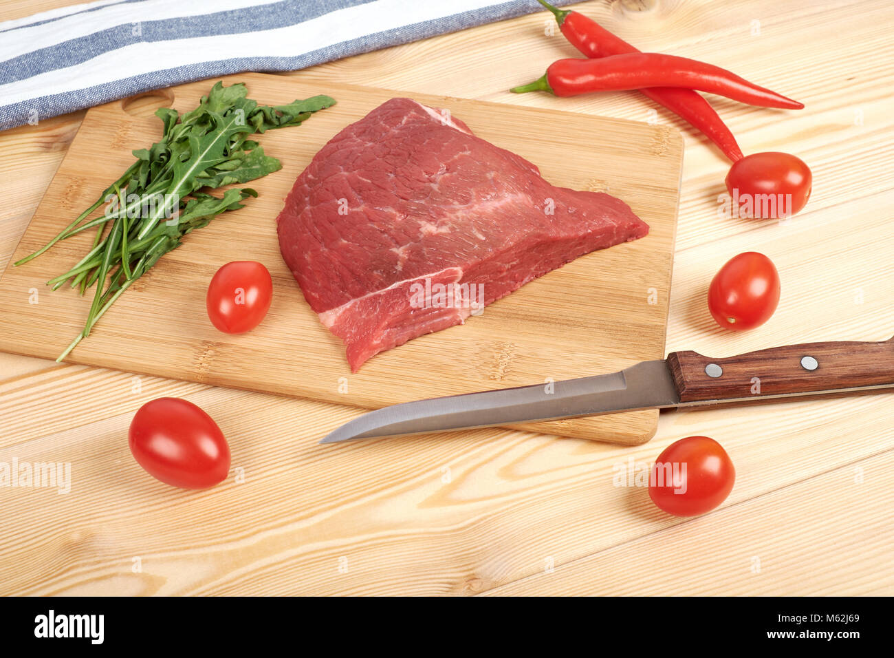 raw meat with vegetables and knife on the board Stock Photo - Alamy