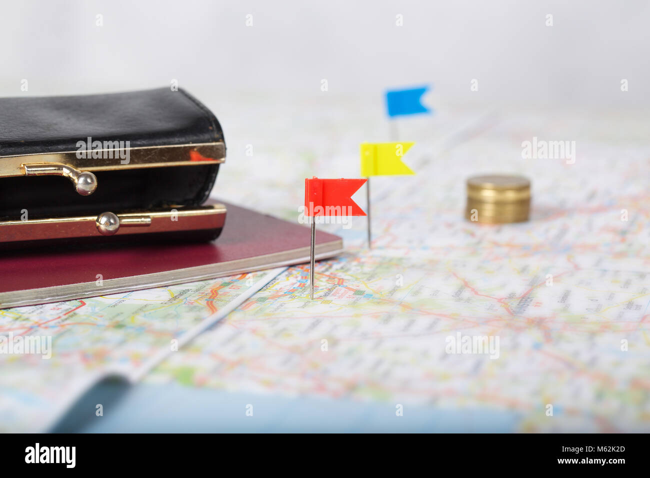 Wallet, coins, pass on a map. Closeup Stock Photo - Alamy