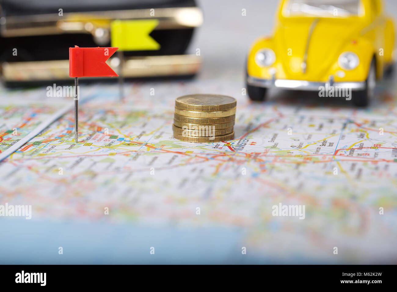 Wallet, coins, pass on a map. Closeup Coins on a map. Mini car in the ...
