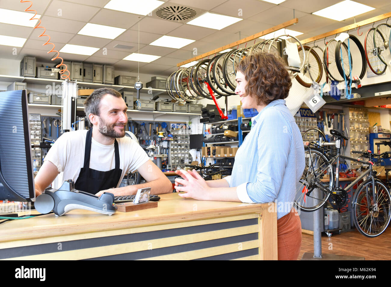 Bicycle shop consulting - salesman and customer in conversation Stock Photo