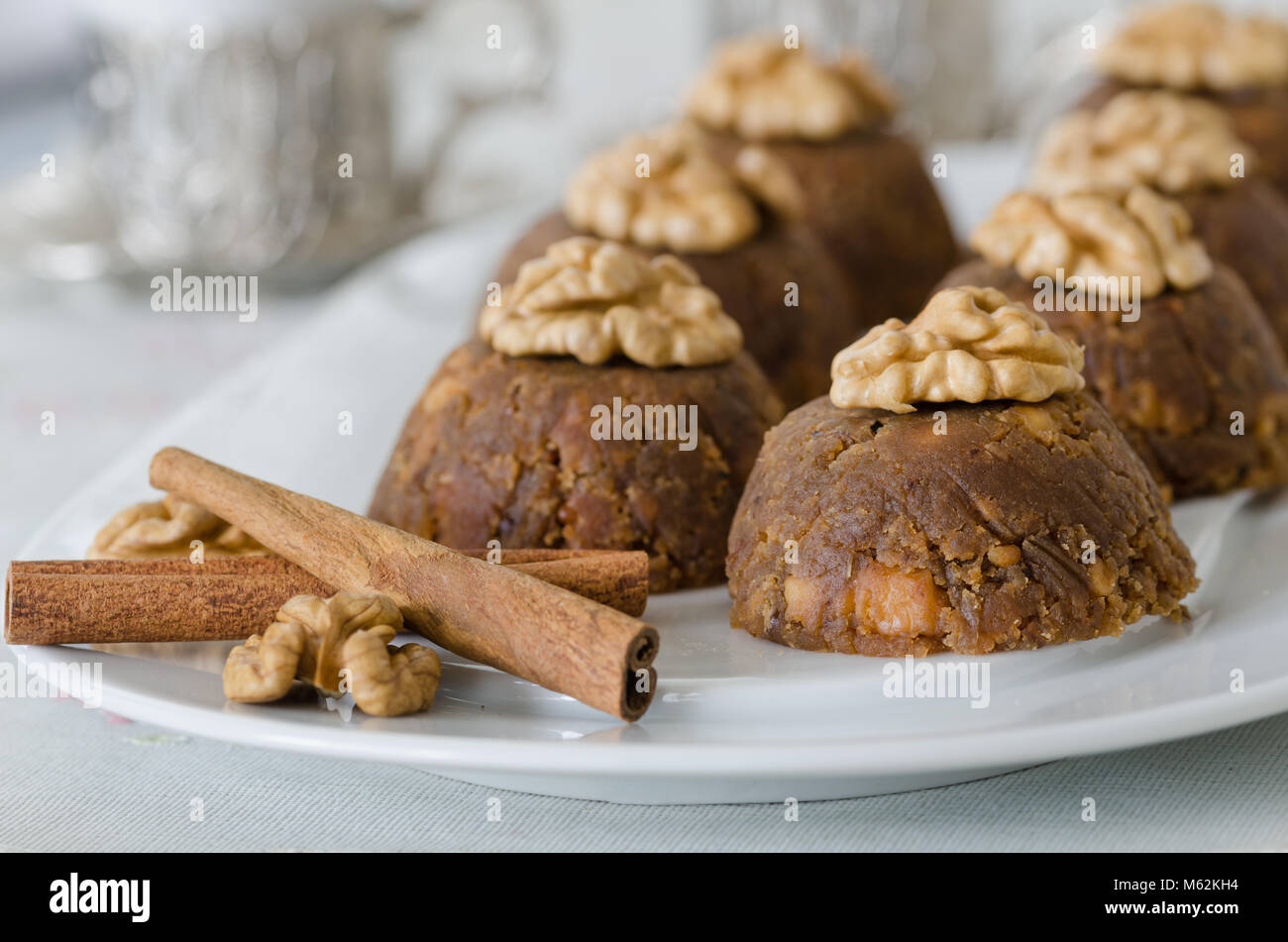 Traditional Turkish sweet dessert halva with walnut on the white plate