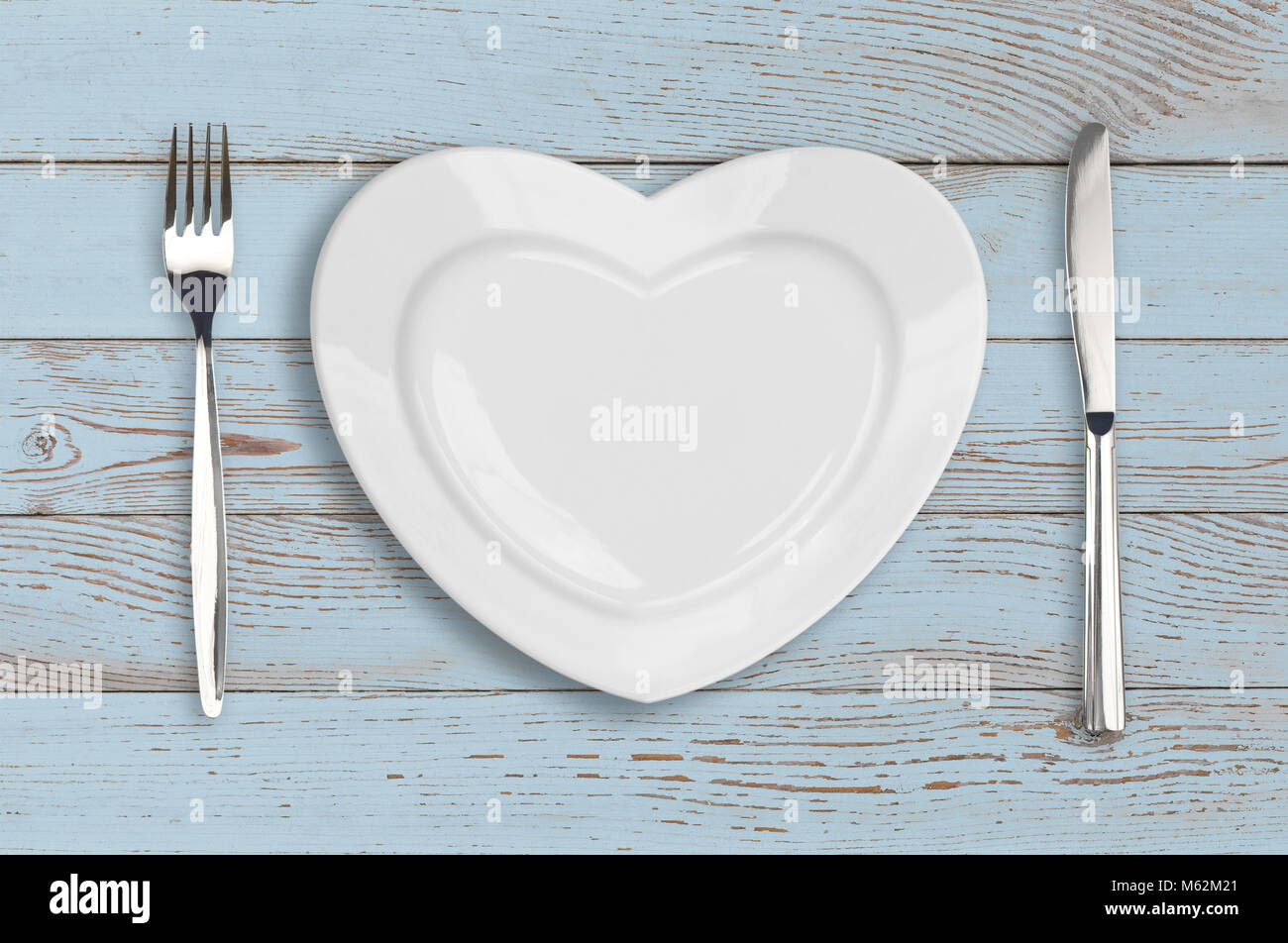 empty heart plate top view on blue wood table Stock Photo