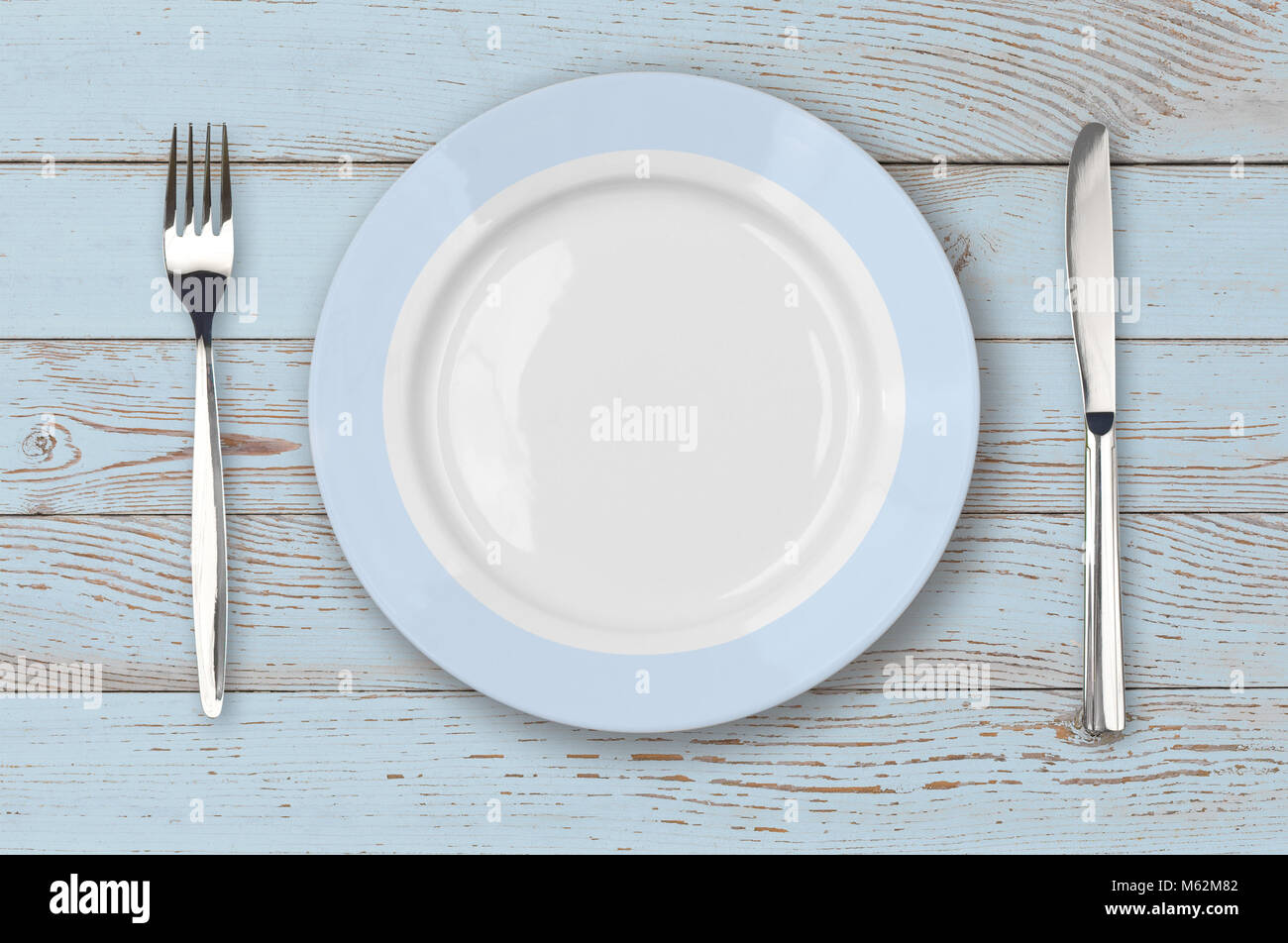 Blue wood table with plate setting top view Stock Photo