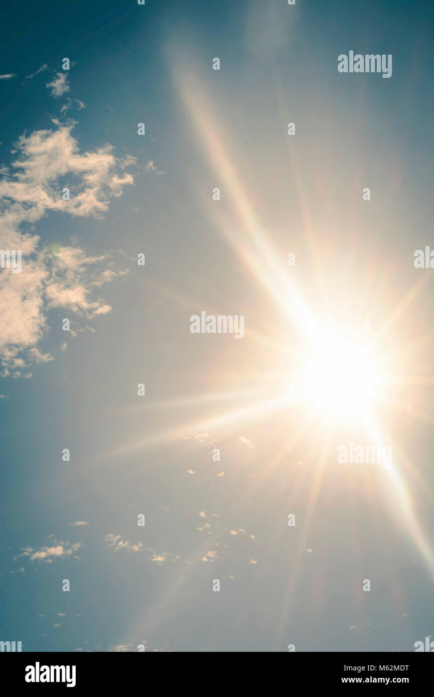 Bright sun in the blue sky Stock Photo - Alamy