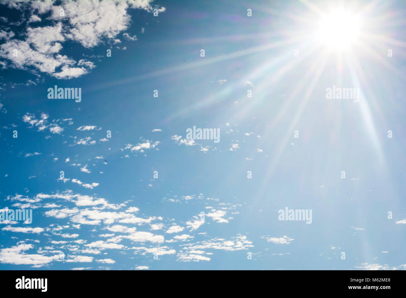 Bright sun in the blue sky Stock Photo - Alamy
