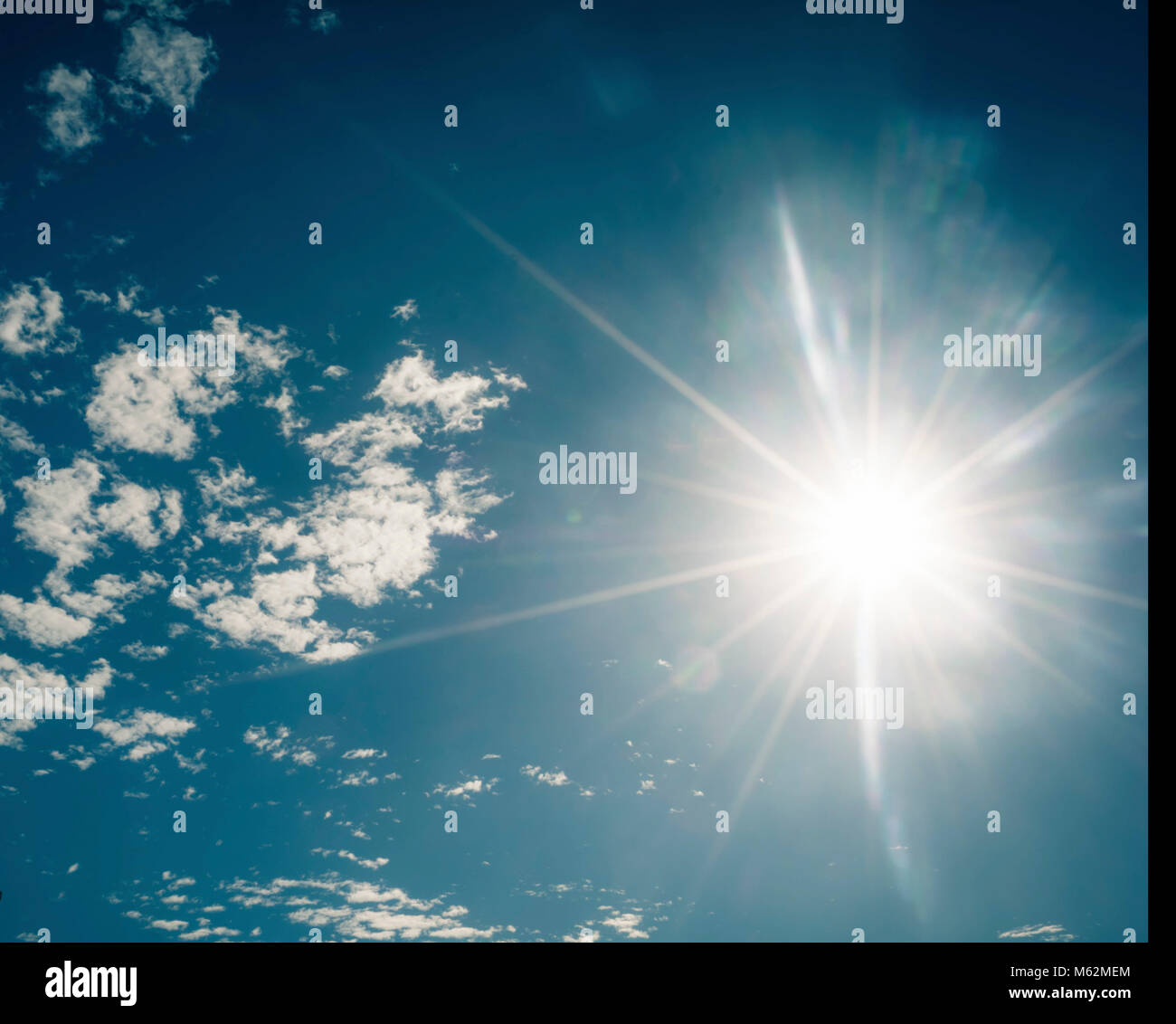 Bright sun in the blue sky Stock Photo - Alamy