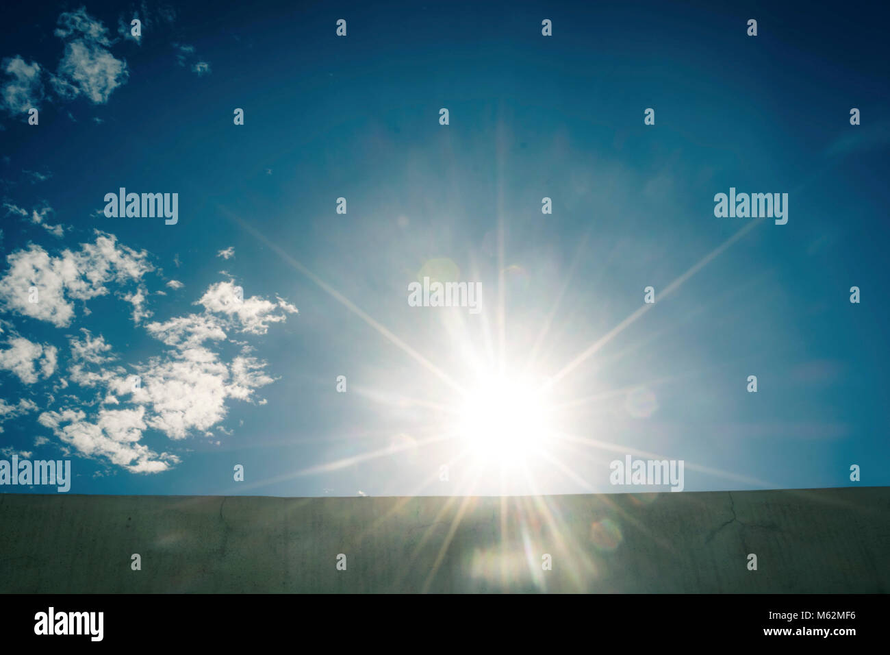 Bright sun in the blue sky Stock Photo - Alamy