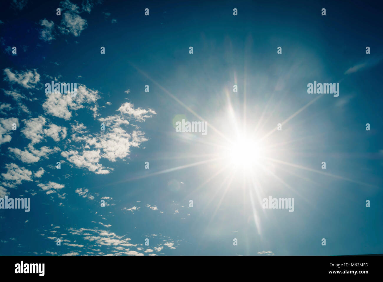 Bright sun in the blue sky Stock Photo - Alamy