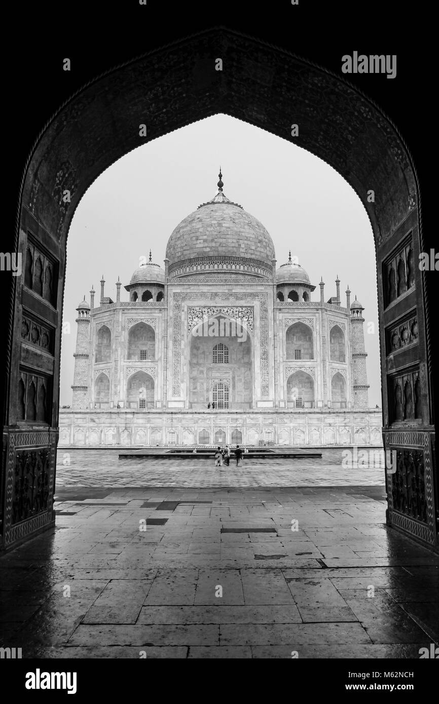 Taj Mahal in black and white framed by the arc of the mosque in Agra, India. Mausoleum unique architecture, world wonder, love concept Stock Photo