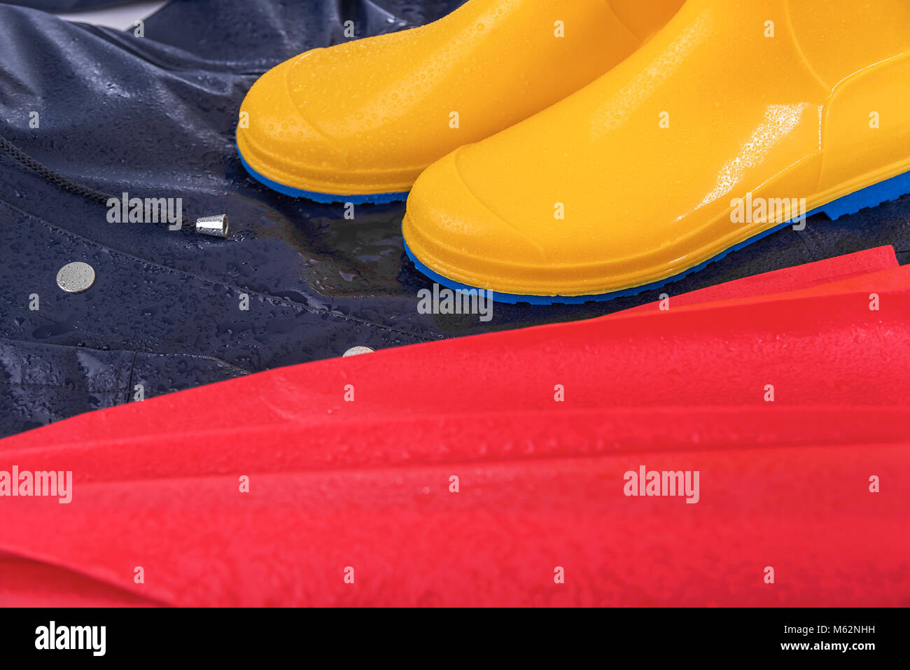 Rubber boots and raincoat and umbrella in rain drops Stock Photo Alamy