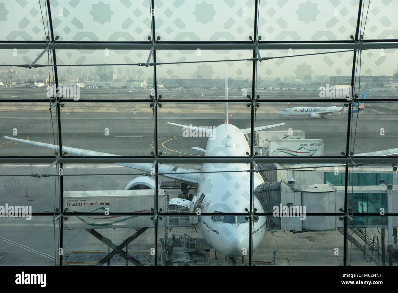 An airplane waiting for take off parked in the Dubai International airport, United Arab Emirates. Stock Photo