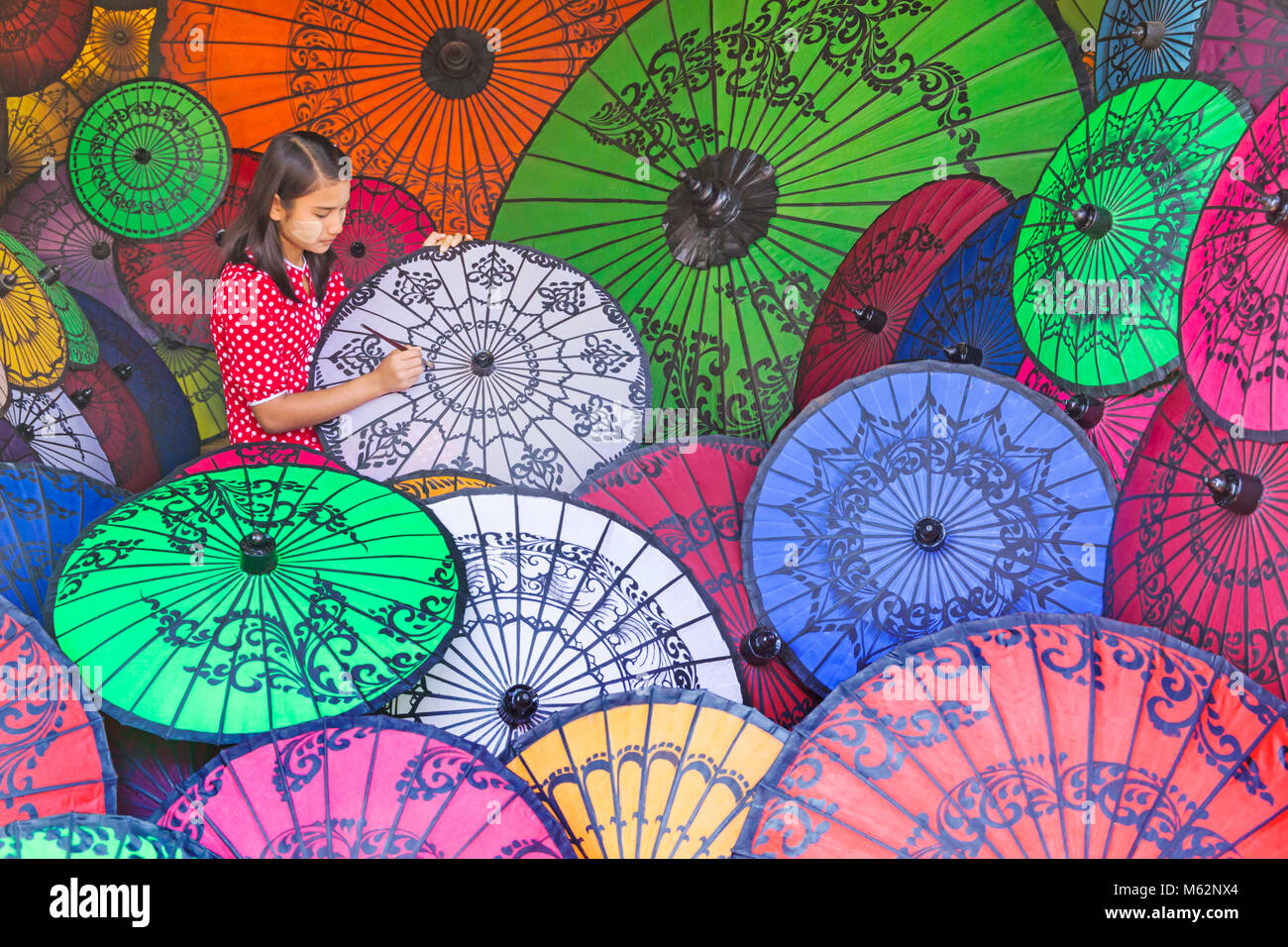 Parasol painter at Bagan, Myanmar (Burma), Asia in February - parasol, parasols, umbrella, umbrellas Stock Photo