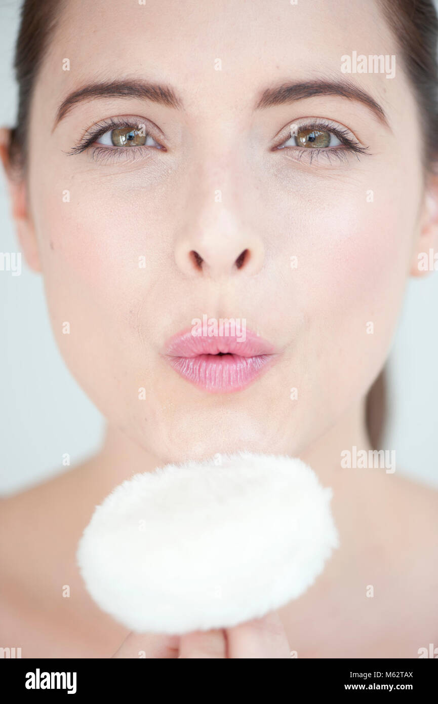 Woman with powder puff Stock Photo