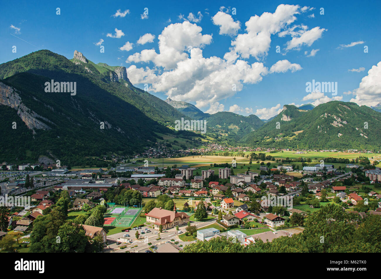 Houses in valley with green mountains and blue sky viewed from the Faverges castle's tower. At the charming village of Faverges. Southeastern France. Stock Photo