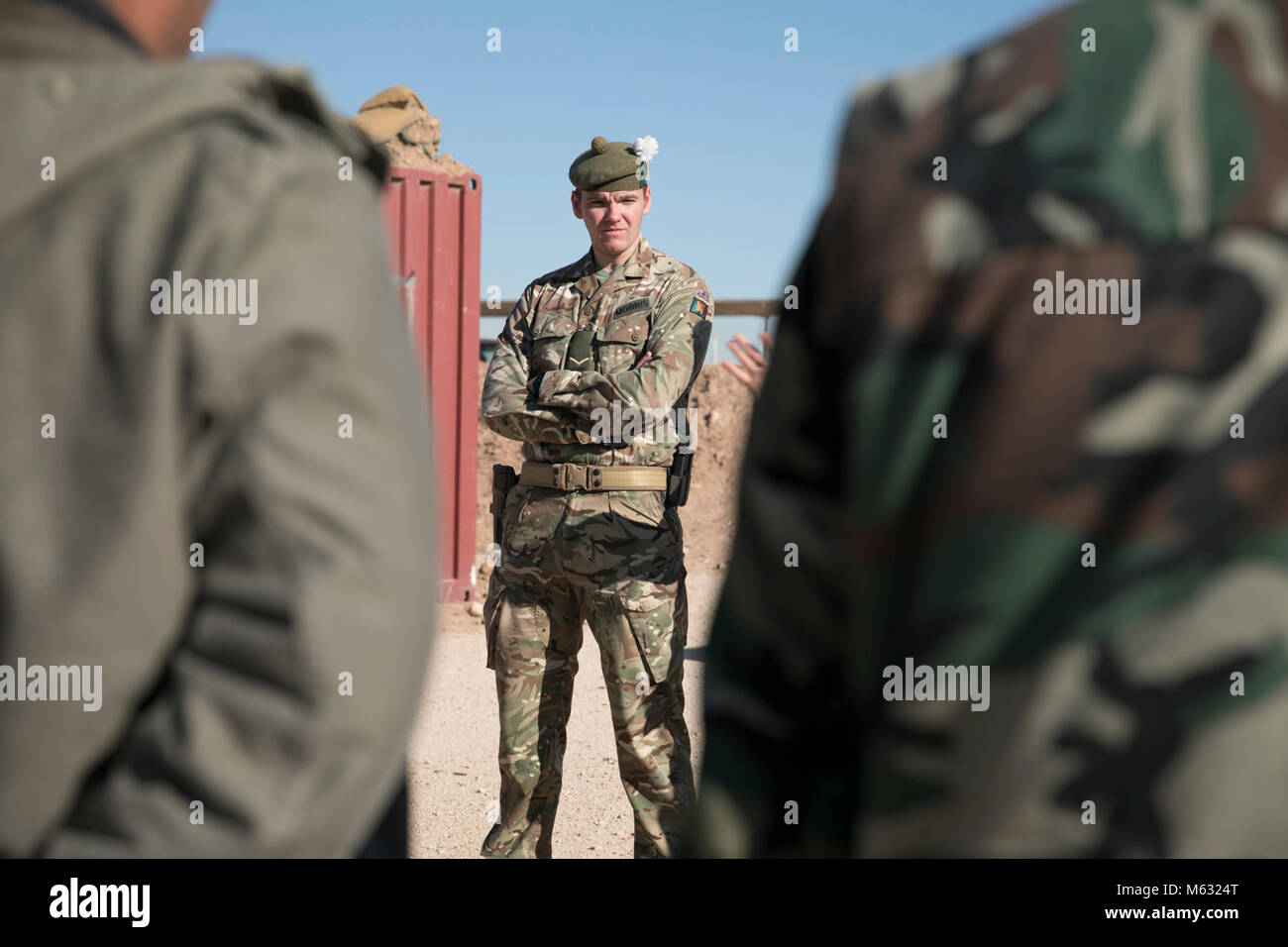 A member of the British training team instructs security force members