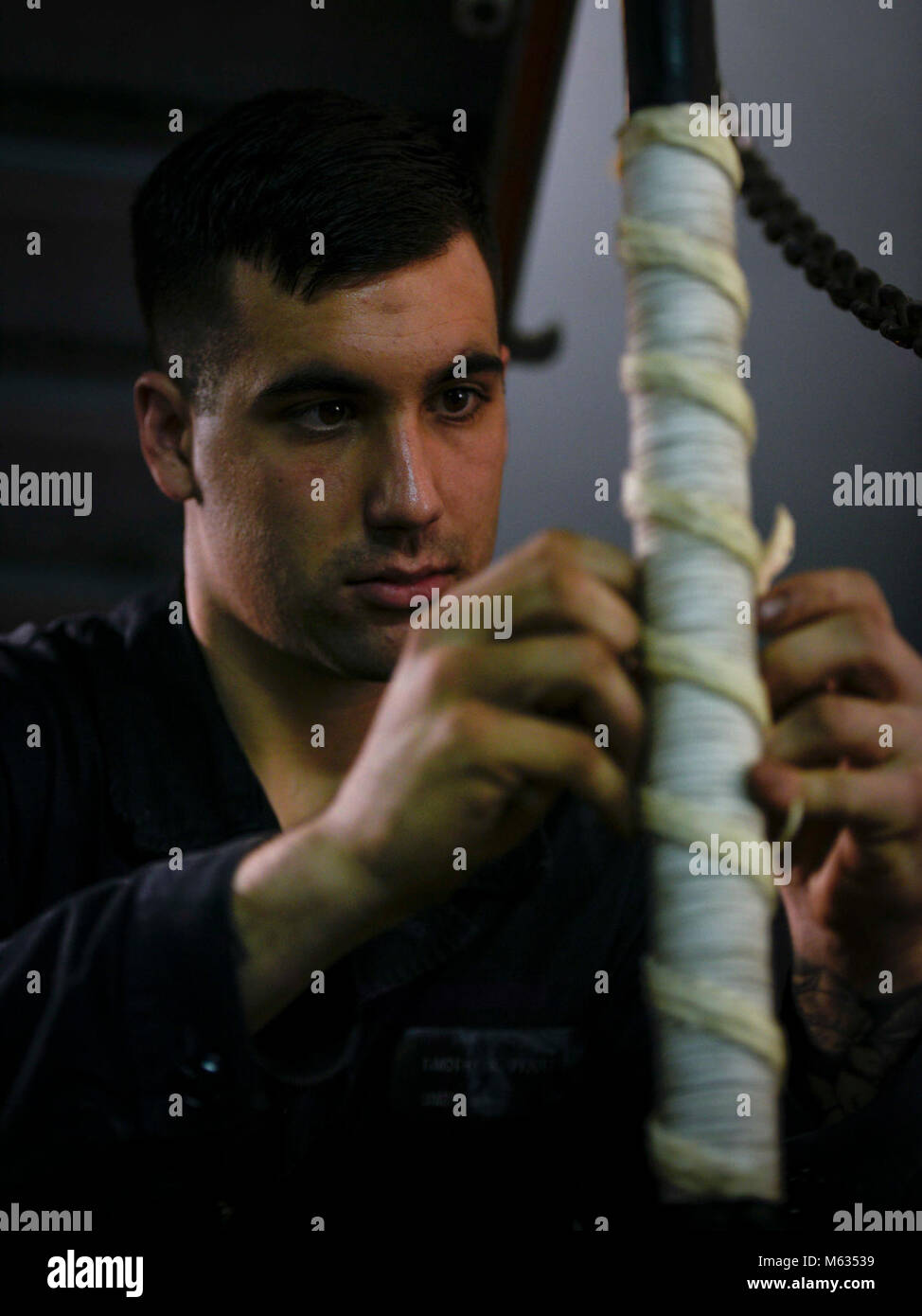 ARABIAN GULF (Feb. 10, 2018) Boatswain’s Mate Seaman Tim Piquette secures fancy work to a