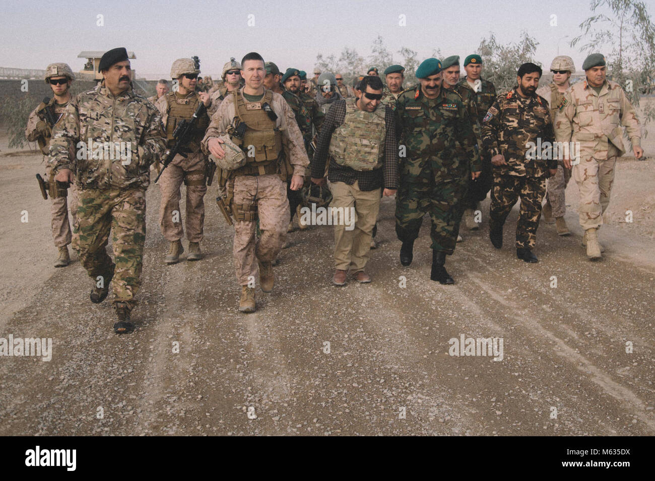 U.S. Marine Brig. Gen. Benjamin T. Watson, commanding general of Task Force Southwest (TFSW), walks with leaders of the Afghan National Defense and Security Force (ANDSF) at Camp Delaram, Afghanistan Feb. 5, 2018. Key leaders from TFSW and the ANDSF conducted a security shura to gain a greater understanding of the security situation through local elders from Nimroz province.   (U.S. Marine Corps Stock Photo