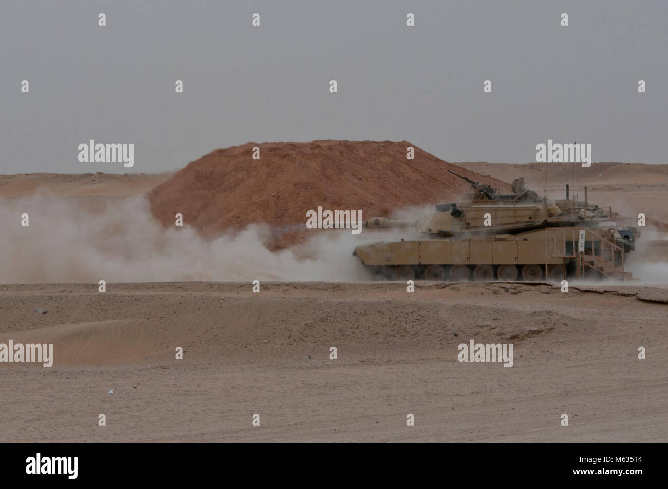 An M1 Abrams tank fires at Udairi Range Complex near Camp Buehring ...