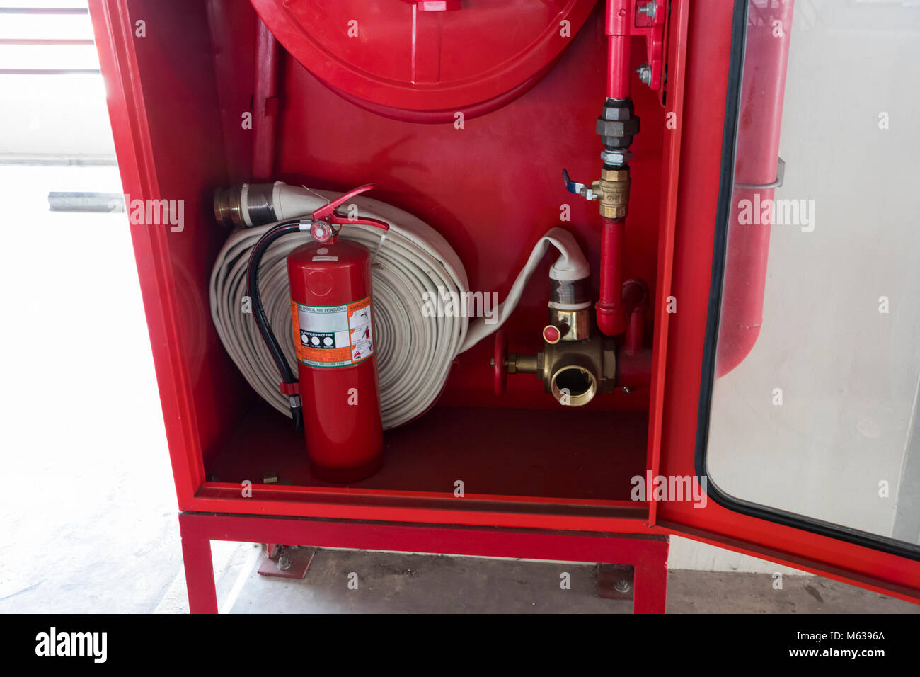 Fire extinguisher and fire hose reel in a parking building Stock Photo