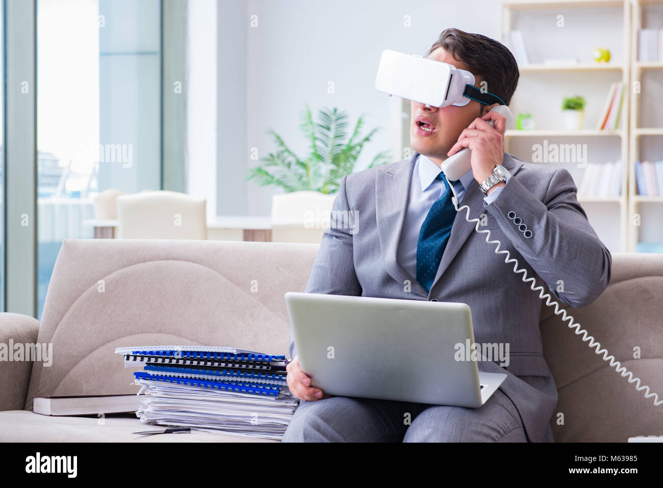 Businessman with virtual reality glasses in modern technology concept ...