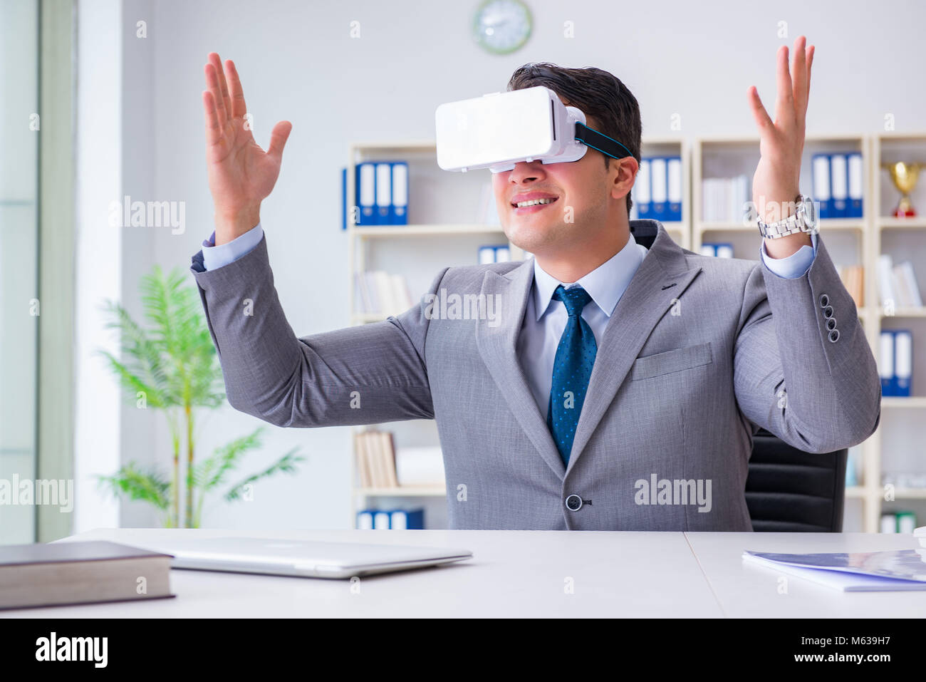 Businessman with virtual reality glasses in modern technology concept ...