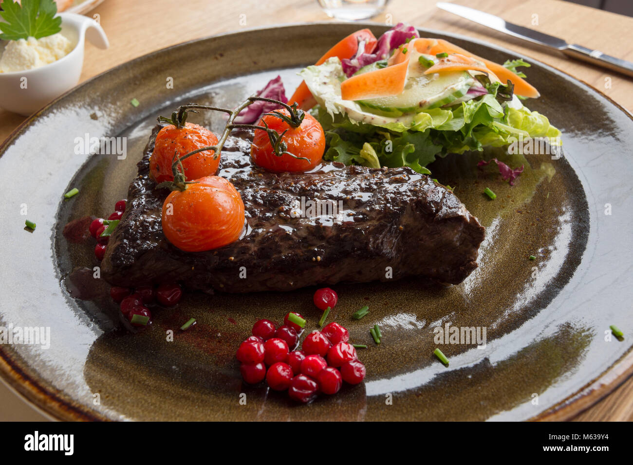 whale steak with tomatoes and currant at the lofoten islands in Norway Stock Photo