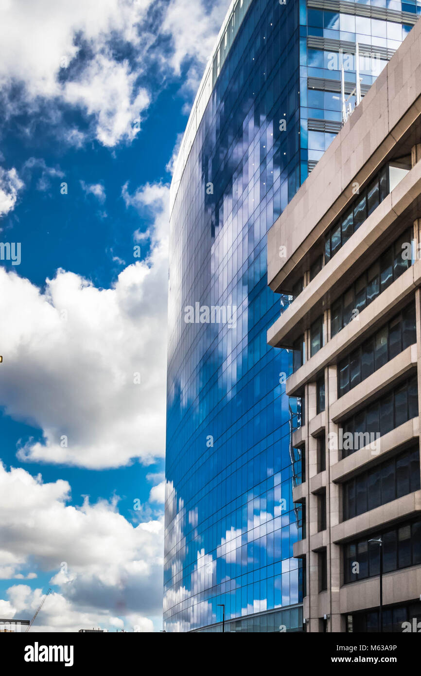 Blue sky and clouds reflection of a glass building in Whitechapel, London Stock Photo