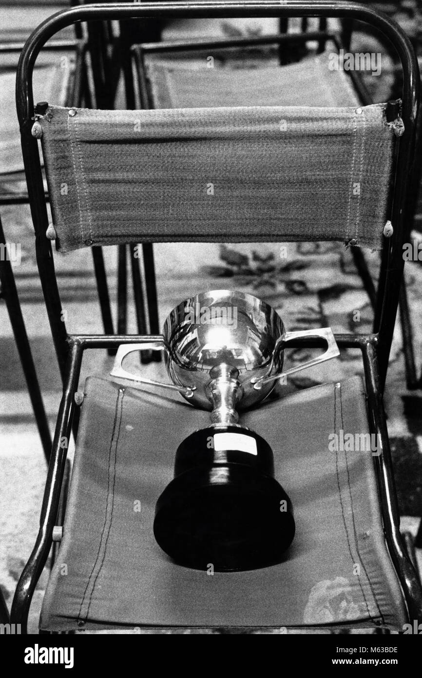 Prizewinners cup resting on chair at small eisteddfod in village hall Talsarnau Gwynedd Wales UK Stock Photo
