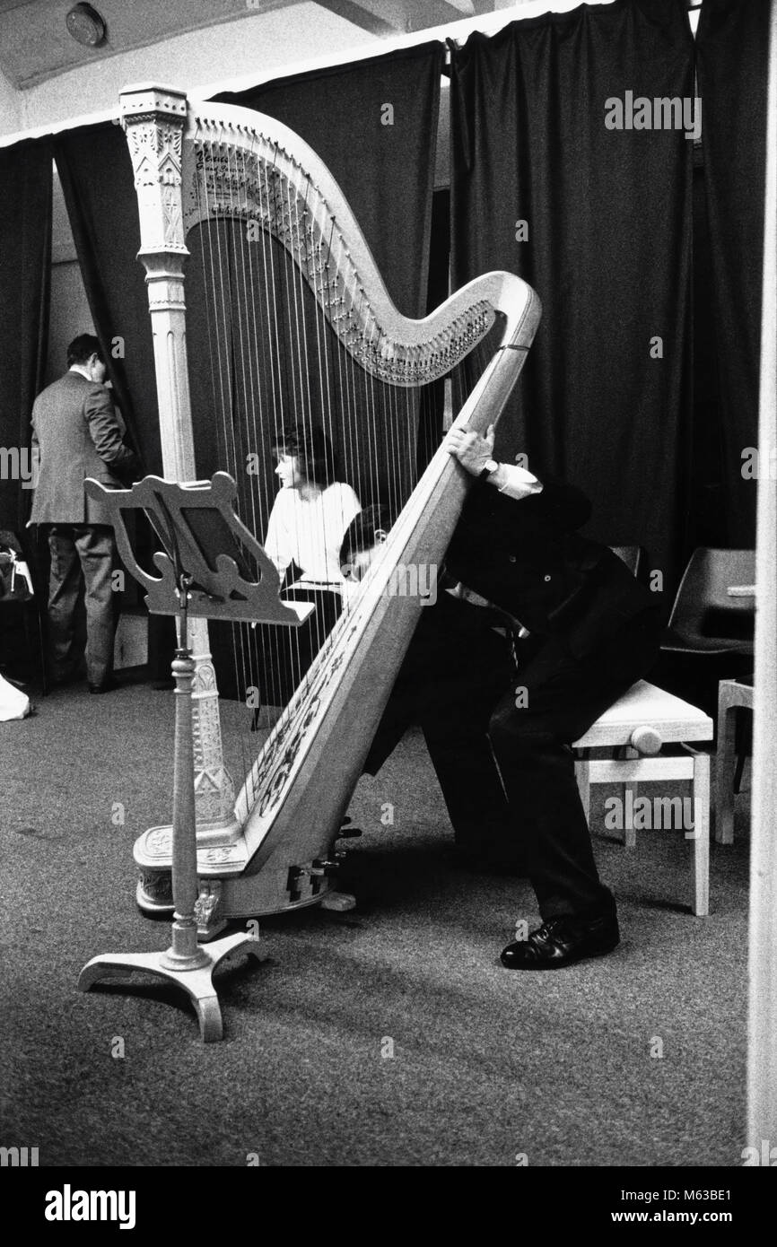 Concert harp on stage at small eisteddfod in village hall Talsarnau Gwynedd Wales UK Stock Photo