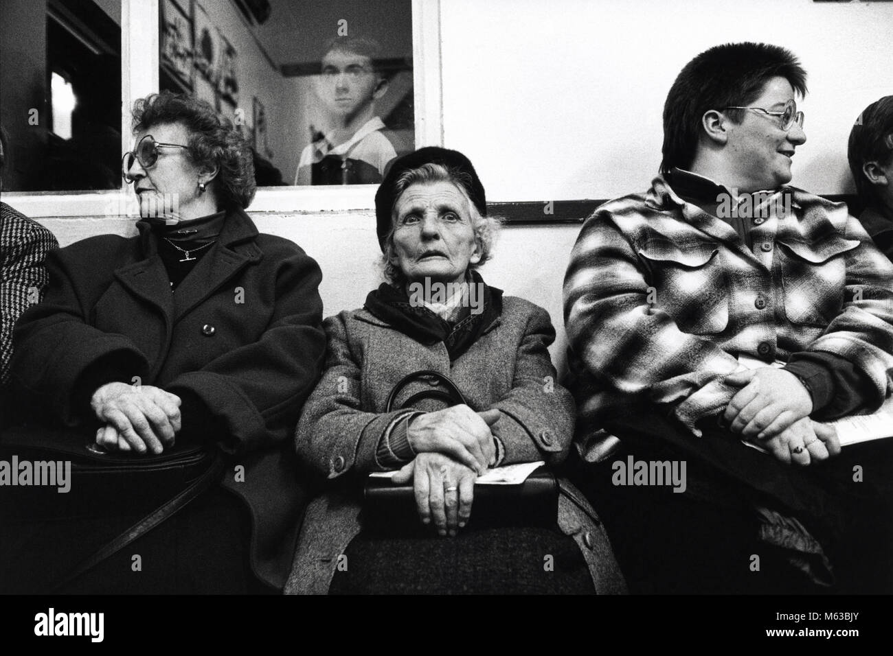 Audience sat at back of hall watching performance at small eisteddfod in village hall Talsarnau Gwynedd Wales UK Stock Photo