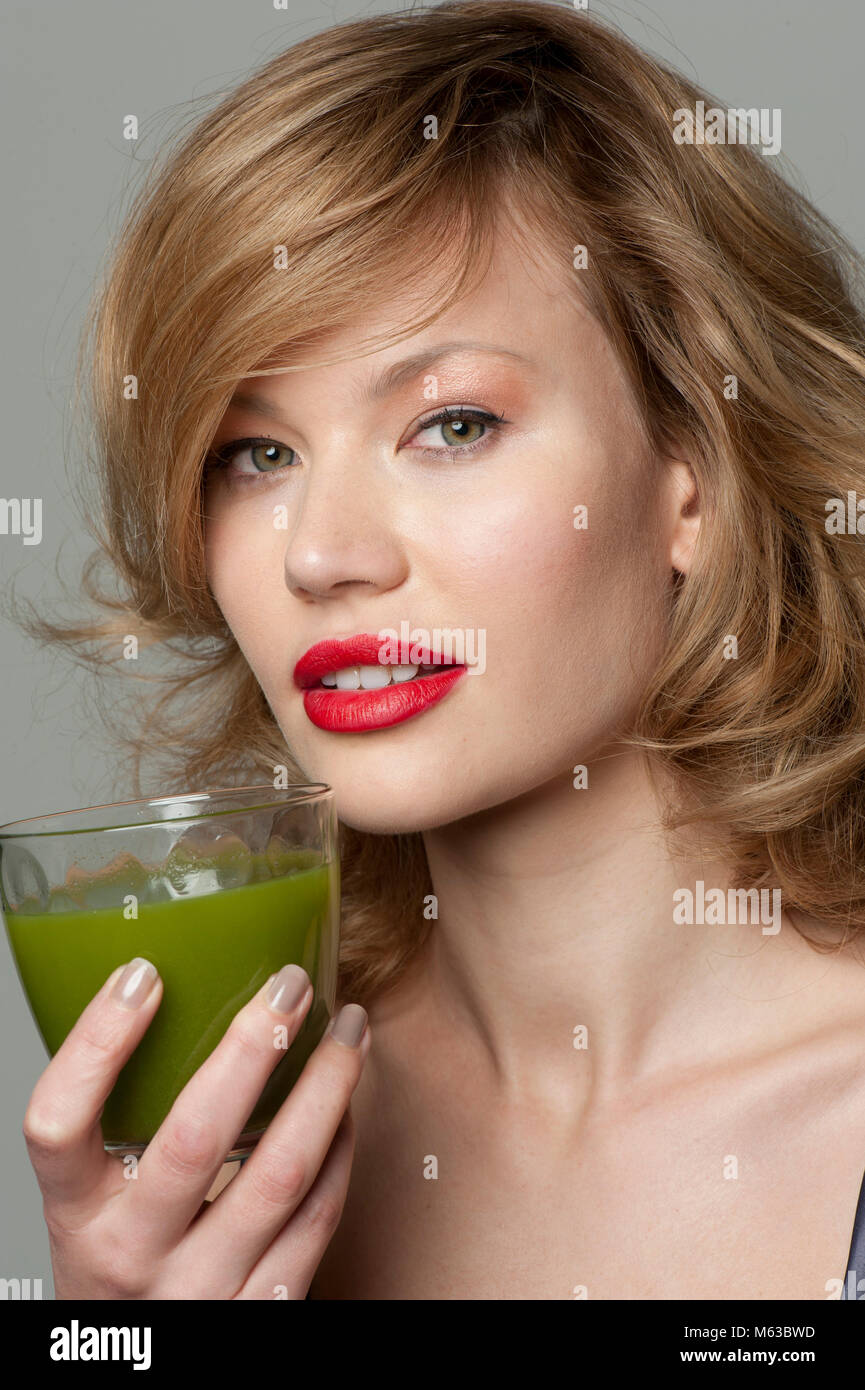 Woman with glass of green juice Stock Photo