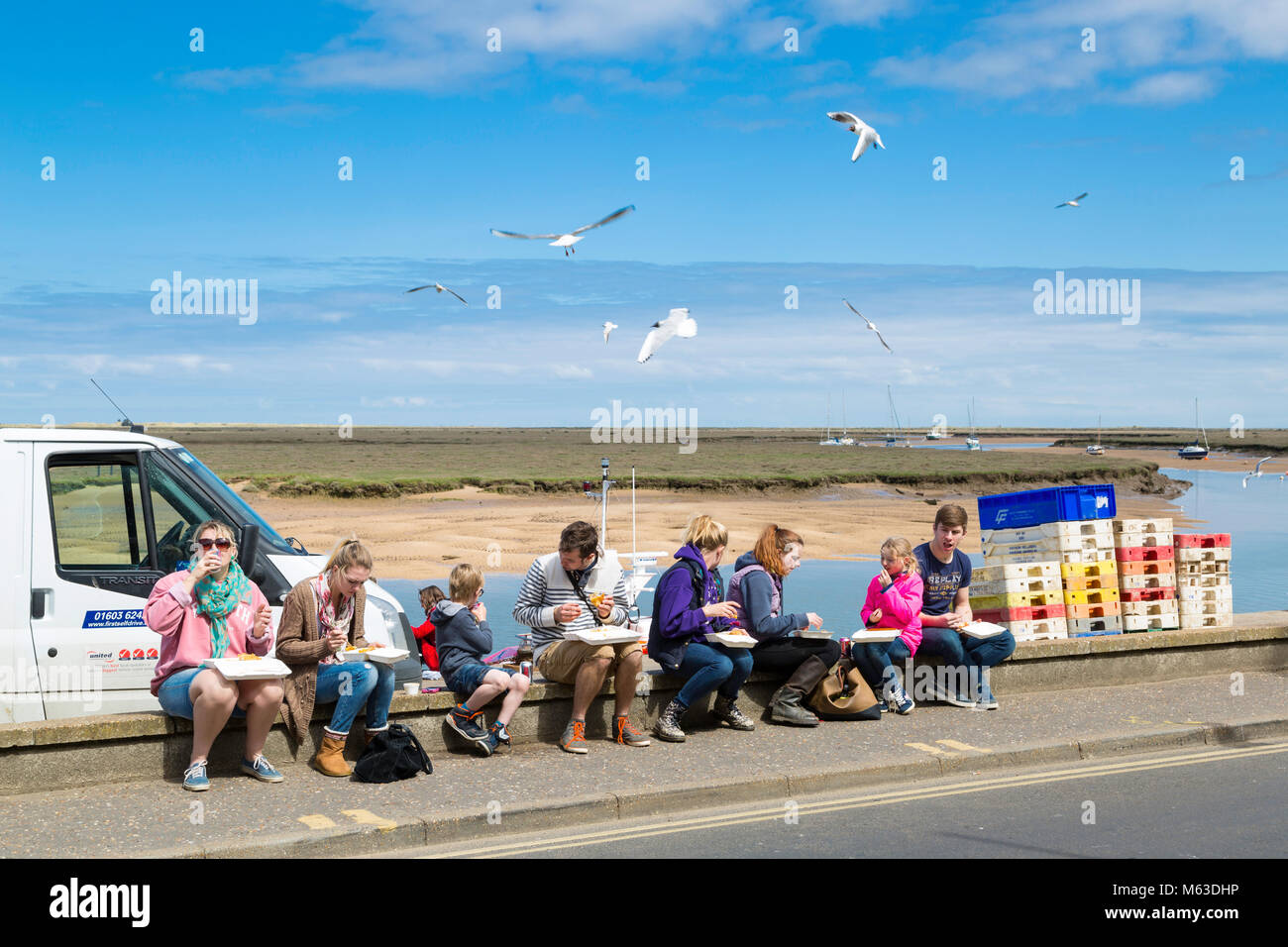 Enjoying fish and chips on the quayside at Wells next the Sea. Stock Photo