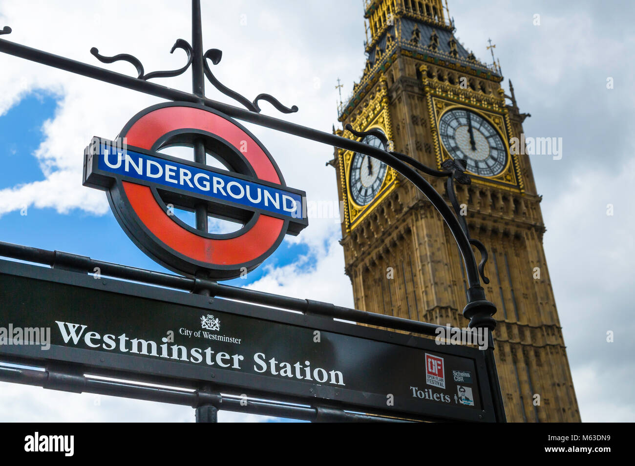 Westminster Station underground sign with the Houses of Parliament behind. Stock Photo