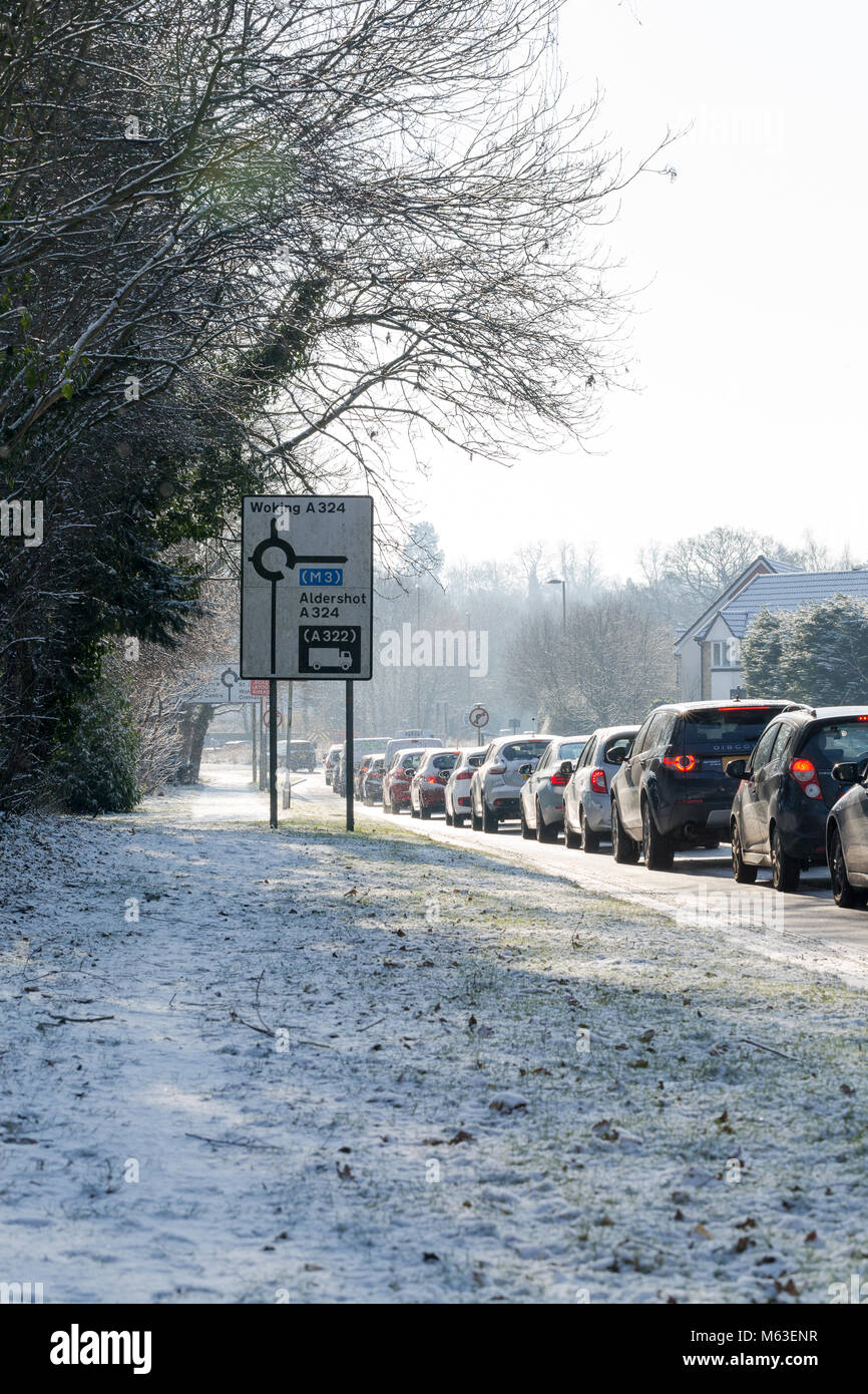 Goldsworth Park, Woking, Surrey, UK. 28th Feb 2018. UK Weather: Slowly driven cars on the slippery road in morning hours in Woking, Surrey making long congestion. Credit: Tom Krok/Alamy Live News Stock Photo