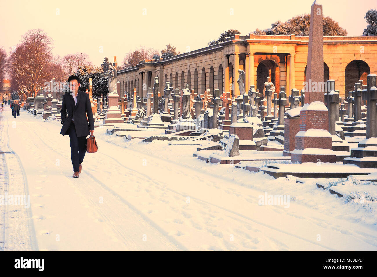 London, UK. 28th Feb, 2018. UK Weather: Central London was blanketed in snow as the cold weather front swept across South East England.A man walks through Brompton Cemetery on the way to work © Brian Minkoff / Alamy Live News Stock Photo