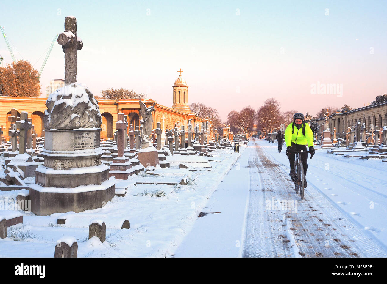 London, UK. 28th Feb, 2018. UK Weather: Central London was blanketed in snow as the cold weather front swept across South East England.A man cycles through Brompton Cemetery © Brian Minkoff / Alamy Live News Stock Photo