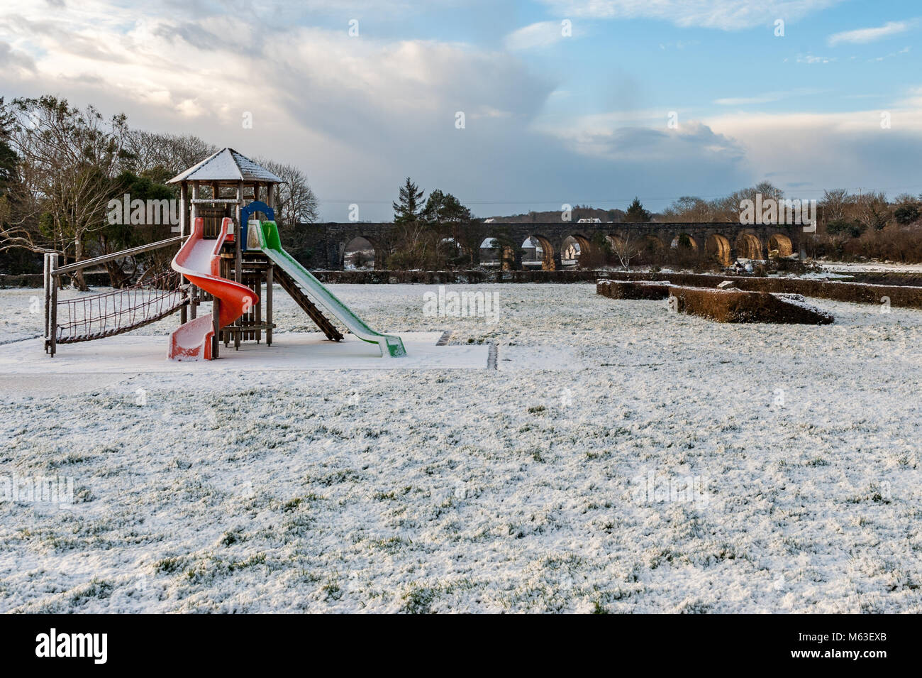 Ballydehob, Ireland. 28th Feb, 2018.  Heavy snow hit West Cork overnight causing widespread travel disruption. Bus Eireann cancelled all school bus services due to the Met Eireann Red Weather Warning.  More snow and freezing temperatures are expected up until the weekend. The playground and 12 Arch Bridge in Ballydehob are pictured covered in a blanket of snow. Credit: Andy Gibson/Alamy Live News. Stock Photo