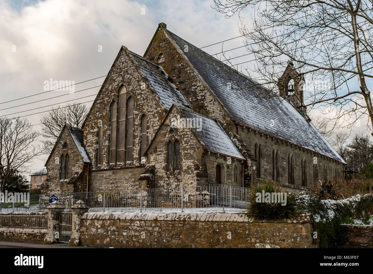 Schull, Ireland. 28th Feb, 2018.  Heavy snow hit West Cork overnight causing widespread travel disruption. Bus Eireann cancelled all school bus services due to the Met Eireann Red Weather Warning.  More snow and freezing temperatures are expected up until the weekend. Holy Trinity Church in Schull received a dusting of snow. Credit: Andy Gibson/Alamy Live News. Stock Photo