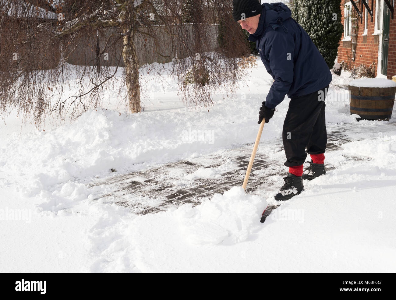 Washington, UK. 28th February 2018. Man clearing path after heavy overnight snow. Washington, Tyne and Wear. England, (c) Washington Imaging/Alamy Live News Stock Photo