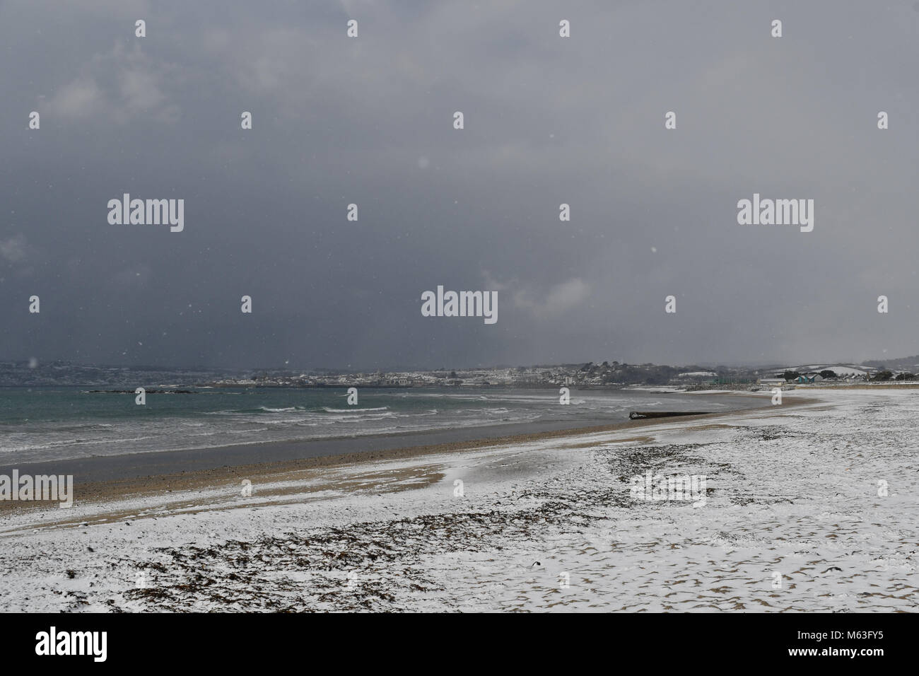 Marazion, Corwall, UK, 28th Feb 2018. UK Weather. Snow on the beach on St Michaels Mount and the beach at Marazion, as the beast from the east hits Cornwall. Credit: Simon Maycock/Alamy Live News Stock Photo