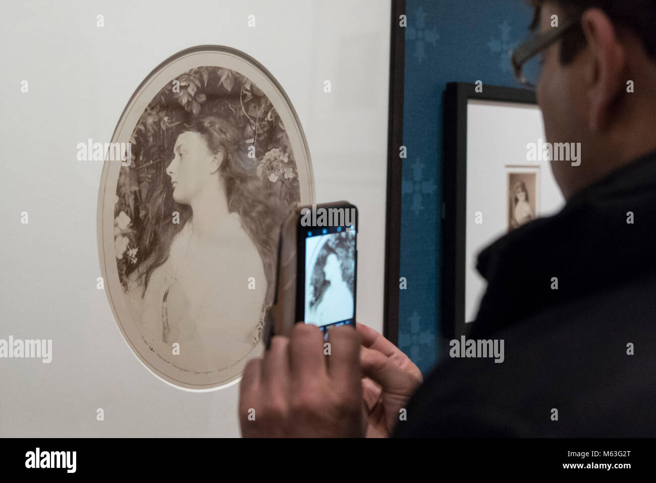 London, UK.  28 February 2018.  A visitor views 'Aletheia (Alice Liddell', 1872, by Julia Margaret Cameron at the preview of 'Victorian Giants:  The Birth of Art Photography' at the National Portrait Gallery featuring works by Lewis Carroll, Julia Margaret Cameron, Oscar Rejlander and Clementina Hawarden. Credit: Stephen Chung/Alamy Live News Stock Photo