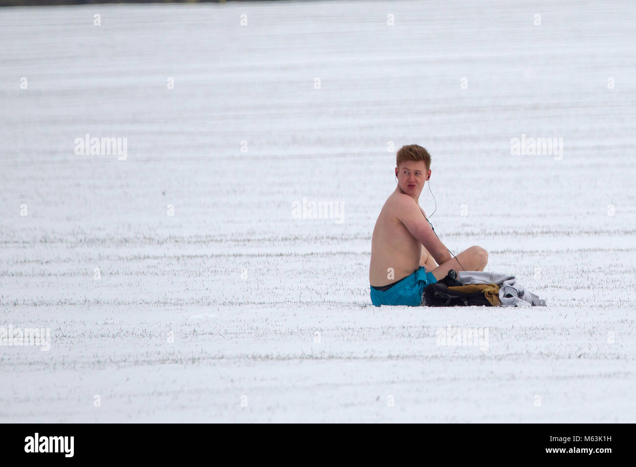 Northampton, England, U.K. Weather. 28th February 2018. Snow early afternoon with temperatures of  -4  in Abington Park and this young man is about in only his shorts. Credit: Keith J Smith./Alamy Live News Stock Photo