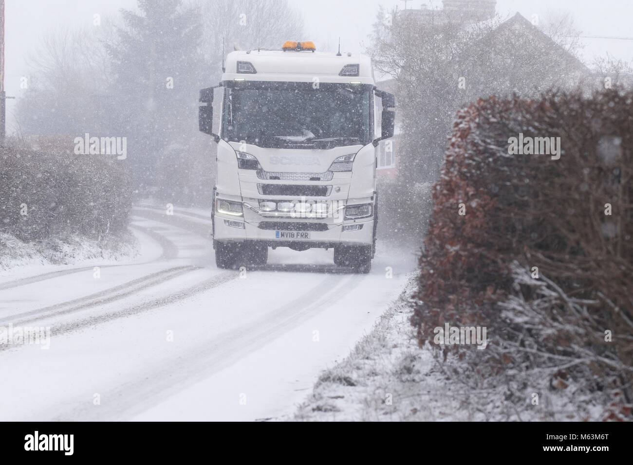 Titley, Herefordshire, UK - Wednesday 28th February 2018 - HGV lorry  driving in heavy snow showers making driving conditions hazardous in rural Herefordshire. Photo Steven May / Alamy Live News Stock Photo