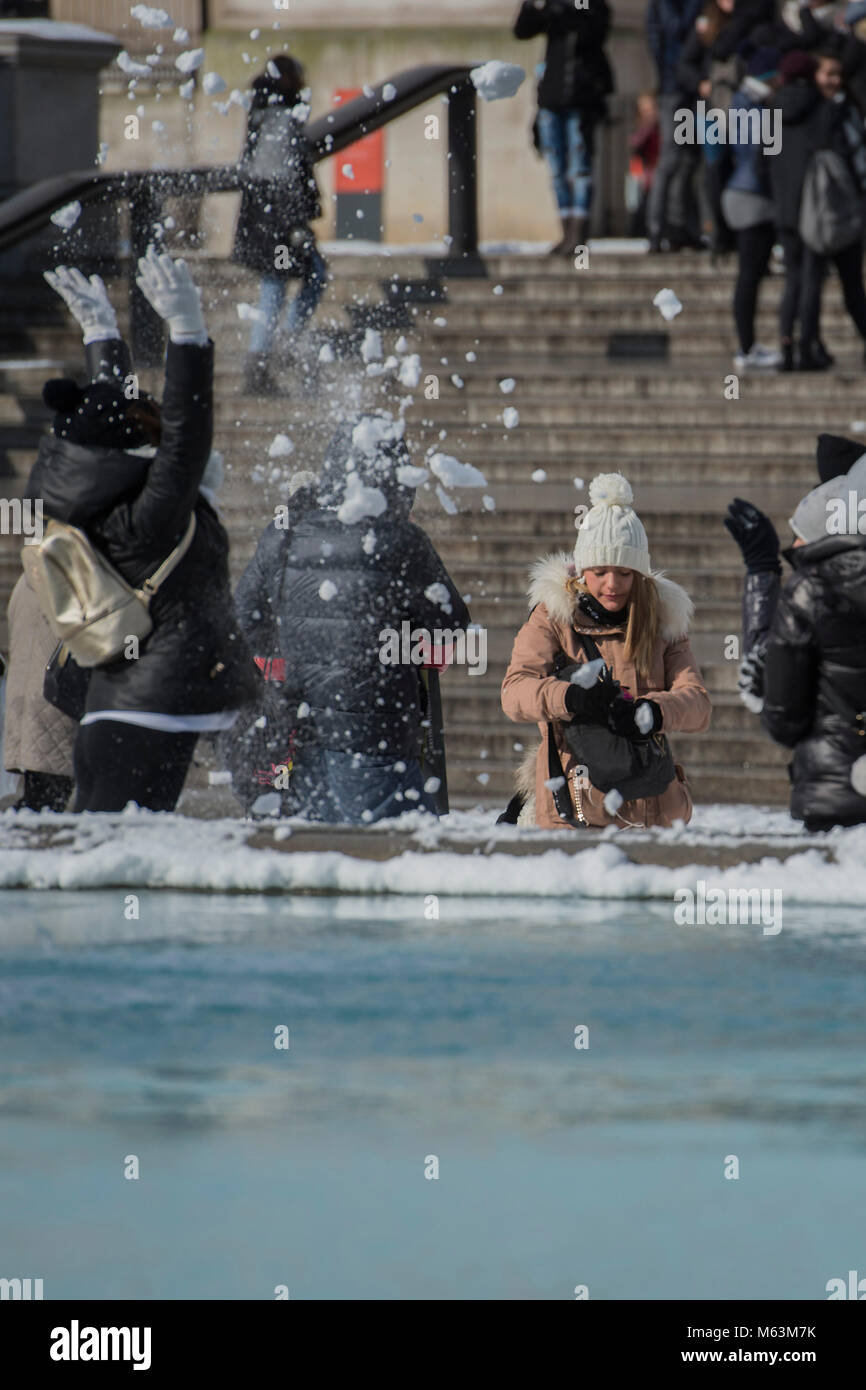 London, UK. 28th February, 2018. The frozen fountains of trafalgar square provide amunition and entertainment for tourists. Credit: Guy Bell/Alamy Live News Stock Photo