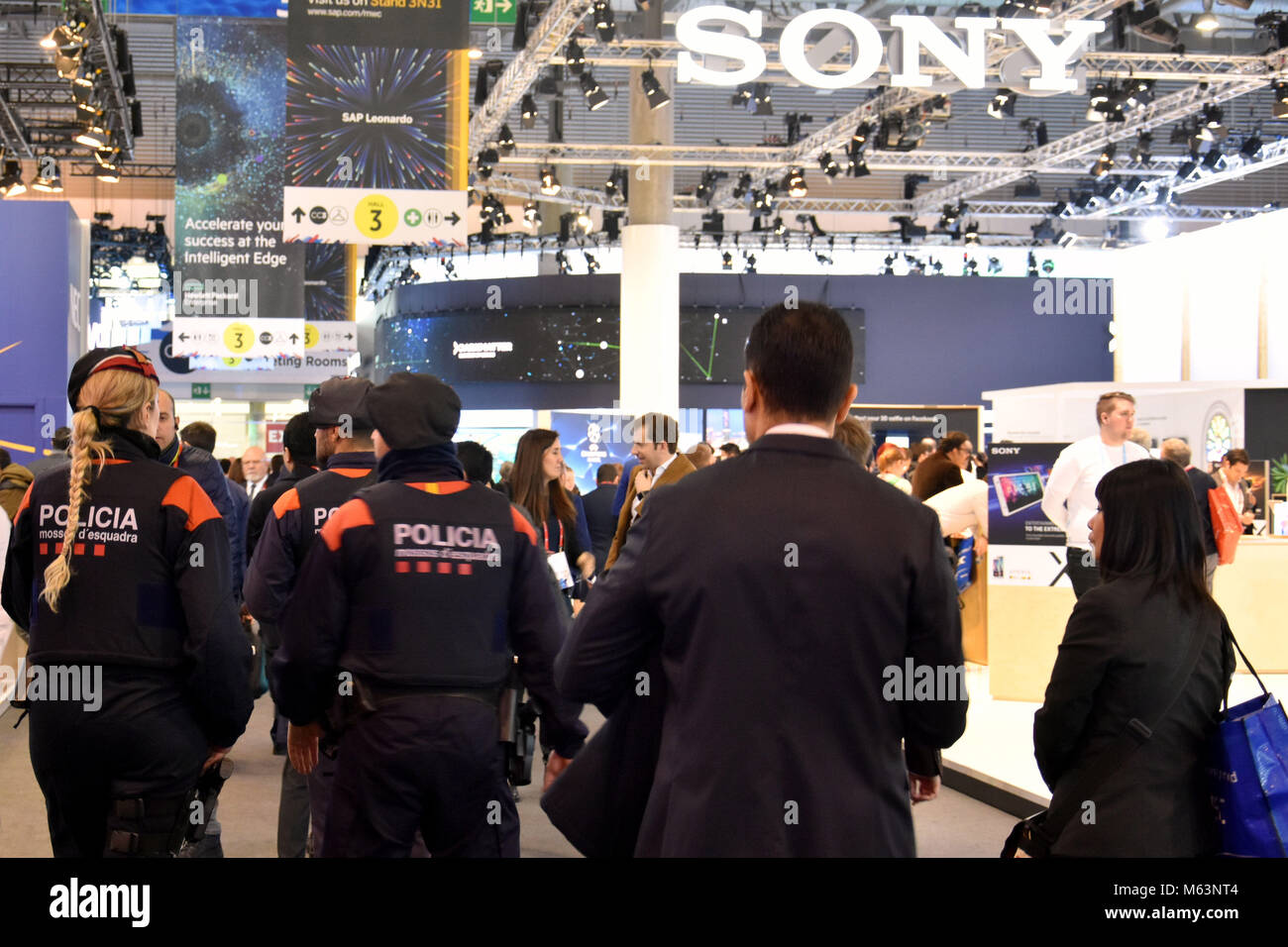 Barcelona, Spain. 28th Feb, 2018. Catalan police seen walking past the SONY stand at the Mobile World Congress.The Mobile World Congress 2018 is being hosted in Barcelona from 26 February to 1st March. Credit: Third day at Mobile Word Congress in Barcelona Ramon Costa  11 .jpg/SOPA Images/ZUMA Wire/Alamy Live News Stock Photo