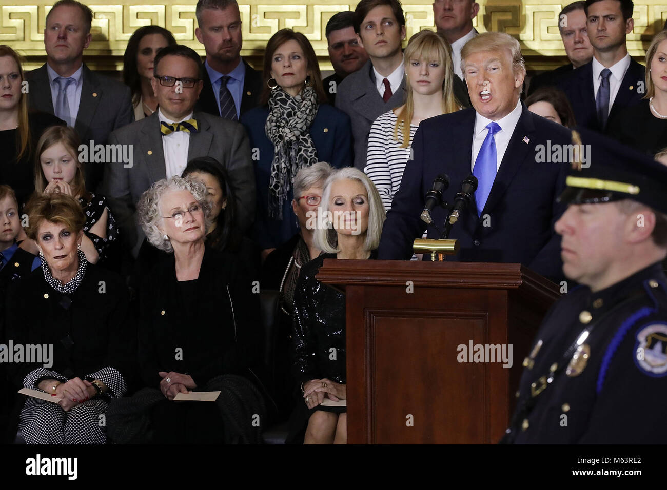 Washington, District of Columbia, USA. 28th Feb, 2018. U.S. President Donald Trump (R) delivers remarks during a memorial ceremony for Christian evangelist and Southern Baptist minister Billy Graham as his daughters (L-E) Gigi Graham, Ruth Graham and Anne Graham Lotz listen in honor in the U.S. Capitol Rotunda February 28, 2018 in Washington, DC. A spiritual counselor for every president from Harry Truman to Barack Obama and other world leaders for more than 60 years, Graham died February 21 at the age of 99. Credit: Chip Somodevilla / Stock Photo